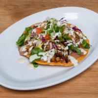Tostada · Fried corn tortilla with your choice of Protein topped with refried beans, veggies, and sour...