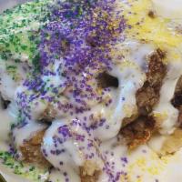 King Cake Bread Pudding (Dd) · A small twist on two New Orleans flavors. Topped with a cream cheese and Mardi gras sugar cr...