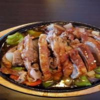 E10 Sizzling Duck · Roast ducks with bell peppers, eggplant, onions in Thai brown sauce.
