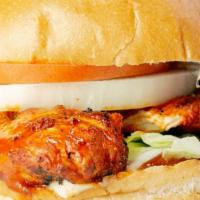 Buffalo Chicken Sandwich · A juicy chicken breast slathered in buffalo sauce with lettuce, tomatoes, onions, ketchup, m...