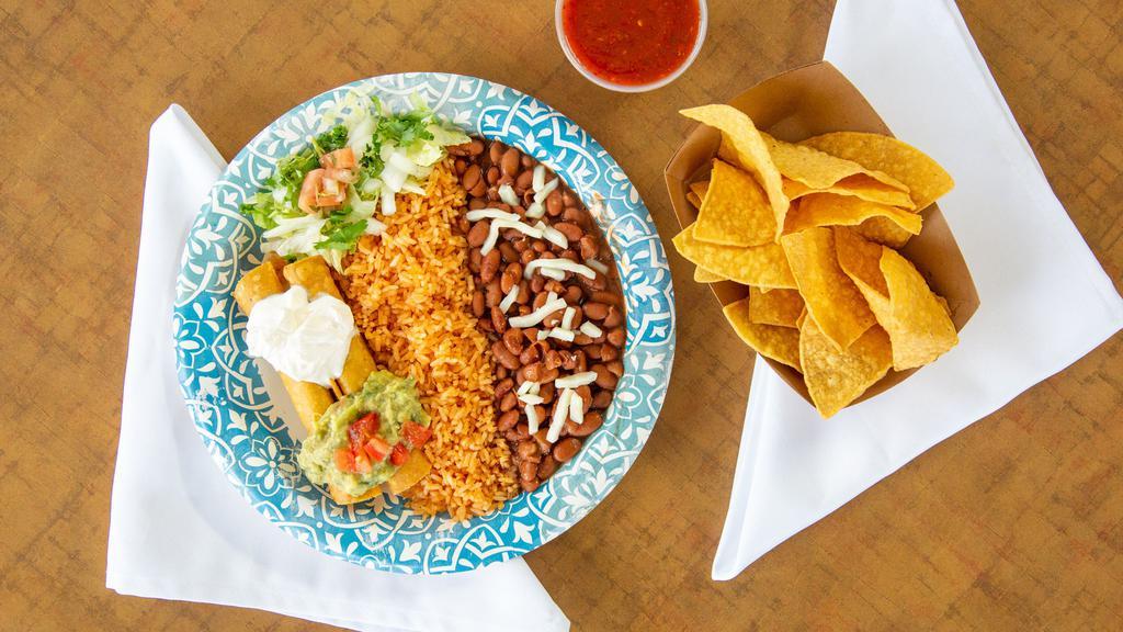 Taquitos · Two deep-fried corn tortillas filled with shredded chicken or shredded beef rolled, deep-fried, and topped with sour cream and guacamole. Rice and pinto or black beans served on the side.