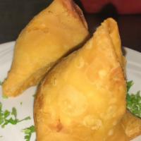 Vegetable Samosa · Crisp spiced patties stuffed with peas and potatoes served with mint and tamarind sauce.