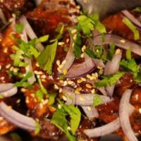 Chicken Wings · 6 pieces of chicken wings with sweet chilly garlic sauce, garnish with sesame seeds.