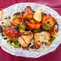Tandoori Mix Grill · Chicken tikka, lamb Seekh kebab, Tandoori shrimp, Tandoori chicken and lamb boti(cube) . Ser...