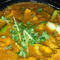 Chicken Karahi · Chicken pieces cooked with fresh green peppers, onions, and tempered with cumin, fennel, and...