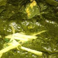 Saag Paneer · Vegetarian. Cubes of homemade cheese smothered with creamy spinach. Served with basmati rice.