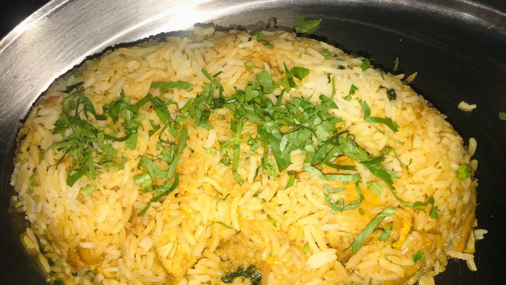 Chicken Dum Biryani · Basmati rice and cubes of chicken cooked with exotic spices and rose water. Served with yogurt raita.