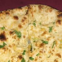 Garlic Naan · Freshly baked white bread topped with garlic and butter.