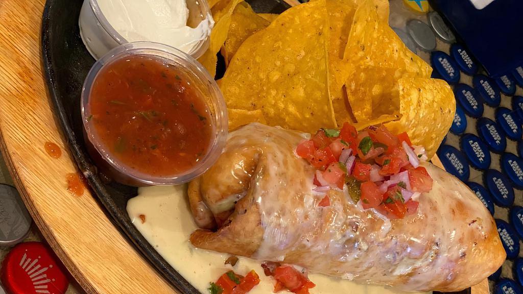 Chimichanga · Fried flour burrito |  choice of meat | rice | peppers & onions | queso blanco | pico de gallo | side of chips & salsa.