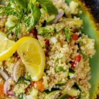 Greek Salad Tabbouleh · Bulgur, freshly chopped mint and parsley, cucumber, onions, tomatoes, topped with lemon juic...