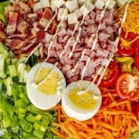 Chef Salad · Iceberg lettuce, topped with ham, turkey, shredded carrots, cucumber, boiled egg, peas, baco...
