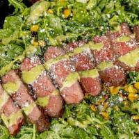 Tex-Mex · Arugula lettuce topped with sliced flat iron steak, cherry tomatoes, cucumbers, roasted corn...