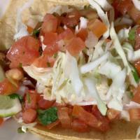 Fish Tacos · Two tacos stuffed with tilapia fish chunks served with a side of pico de gallo, lettuce and ...