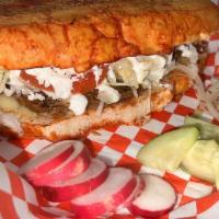 Pambazo  · meat choice or potato 
with chorizo, Served with
refried beans, lettuce,
cream and cheese
