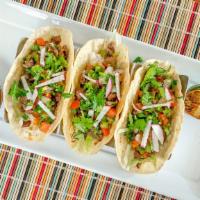 Tacos · Choice of beef or chicken, served with shredded lettuce, pico de gallo, and salsa verde.
