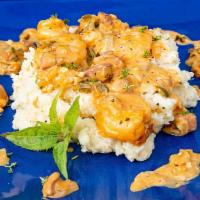 Shrimp And Grits · A down home treat with andouille, shrimp, roasted red peppers in a savory sauce served over ...