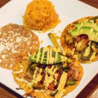 Gourmet Tacos · Fresh homemade chipotle corn tortillas, melted cheese, filled with choice of protein, topped...