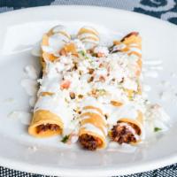Chicken Flautas · Chicken rolled in crispy corn tortilla, black bean purée, crema Mexicana, morita salsa.