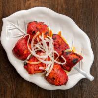 Chicken Tikka Boneless · Six pieces of boneless chicken pieces marinated with yogurt, spiced and broiled in an oven.