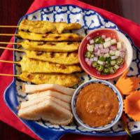 Satay · Six pieces. Skewers of marinated chicken grilled and served with peanut sauce and cucumber r...