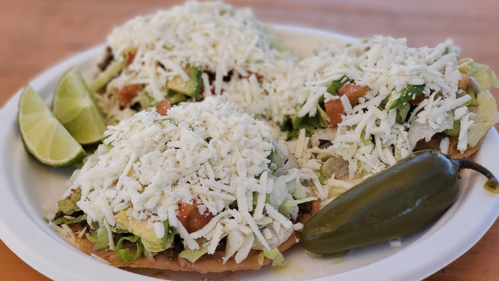 Beef Tostadas (Order Of 3) · Bistec, refried beans, beef, lettuce tomato, avocado, queso fresco, and salsa on the side.