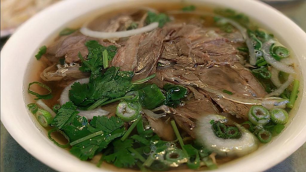 Brisket Pho (Phở Chín) · Traditional Vietnamese soup made with a rich beef broth, tender rice noodles, and choice of protein. Comes with cilantro, white onions, and green onions.