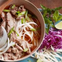 Spicy Beef Noodles (Bún Bò Huế) · Central Vietnamese spicy soup with rice vermicelli, sliced beef, Vietnamese ham and topped w...