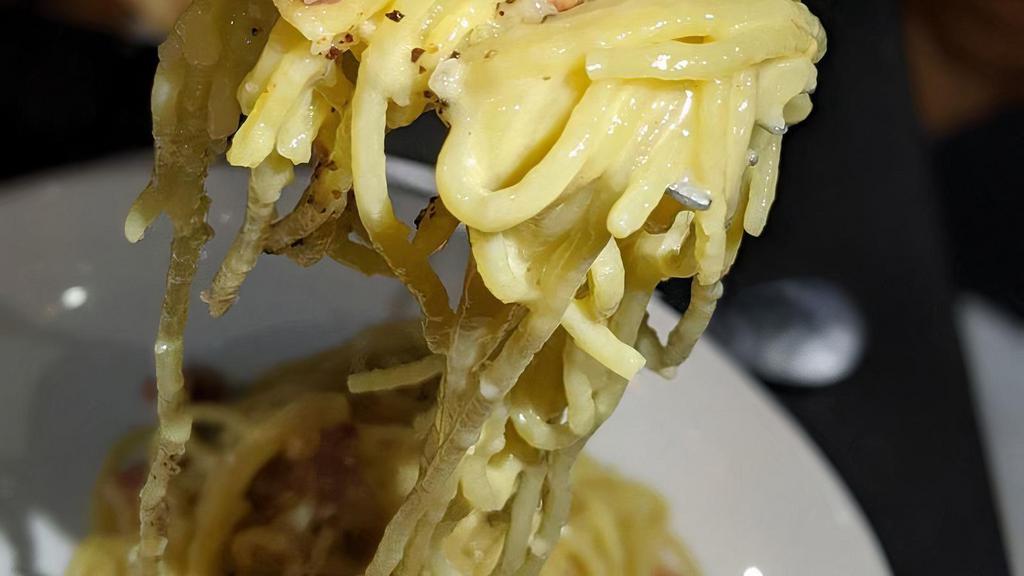 Carbonara · spaghetti, crispy guanciale, egg, parmigiano, pecorino, freshly ground black pepper
