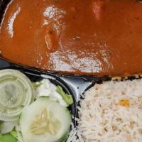 Chicken Tikka Masala · Chunks of chicken cooked in tomato and creamy sauce. Served with rice, bread, and salad.