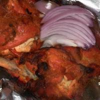 Tandoori Chicken · Two pieces chicken leg marinated in yogurt and spices. Served with rice, bread, and salad.