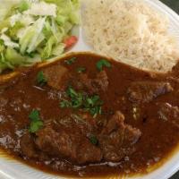 Lamb Curry · Slow cooked chunks of lamb cooked in a special gravy and spices. Served with rice, bread, an...