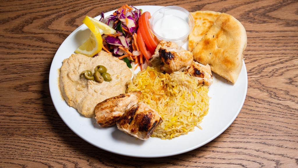 Chicken Shish Kabab · Ground chicken marinated in ginger, garlic, and house spices. Served with rice, bread, and salad.