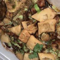 Samosa Chat · Chopped crispy samosas, chick peas, onion, cilantro drizzled with tangy salty spices and tam...