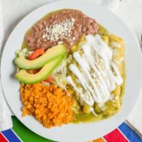 Enchiladas Verdes / Green Enchilada · Served with charro beans and Mexican rice.