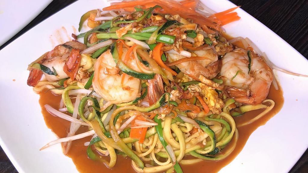 Zucchini Noodle Pad Thai · Spiralized zucchini and carrot noodles tossed in tamarind sauce with eggs, peanuts, and bean sprouts
