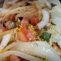 Shrimp Tacos · Cajun seasoned shrimp over cilantro lime slaw topped with avocado, pico de Gallo and cheddar...