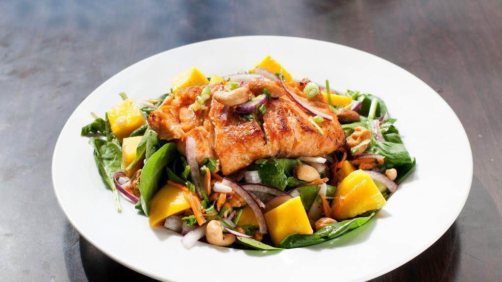 Mango Salsa Salmon · Pan seared salmon topped with a very fresh and richly flavored of Thai mango salsa, cashew nuts on the bed of spinach.