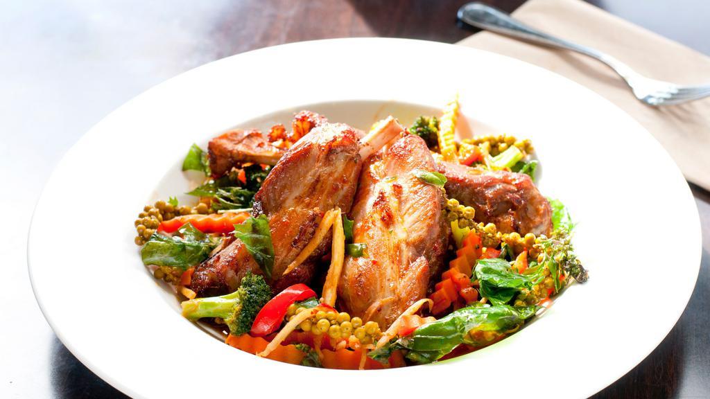 Spicy Pork Shank · Stirred fried tender pork shanks with Thai herbs, chili, young pepper corn, kachai, lemongrass, lime leave with hot and spicy garlic sauce and steamed vegetables.