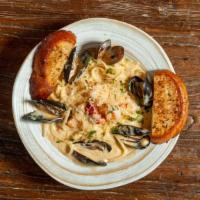 Seafood Linguine · Maine lobster, lump crab, shrimp and mussels tossed in a Parmesan cream sauce served garlic ...