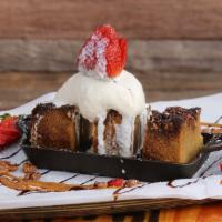 Snickers Bread Pudding · Served hot with vanilla bean ice cream on the side and a drizzle of chocolate & caramel syrup.