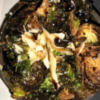 Brussel Sprouts · Flash-fried, crunchy brussel sprouts tossed in garlic Parmesan butter, shaved Parmesan, bals...