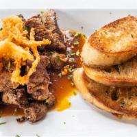 Cajun Tender Tips · Blackened tenderloin beef tips, tossed in our house steak sauce, served with bread