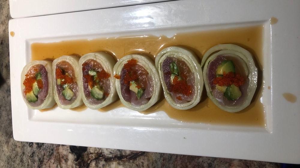 Narudo Roll · 6 pieces. Tuna, salmon, yellowtail, avocado, scallion, tobiko wrapped in cucumber, and served with ponzu sauce.