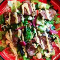 Asian Steak Salad · Grilled flat iron, romaine & kale, grape tomatoes, red onion, cucumber, mint, cilantro, thai...