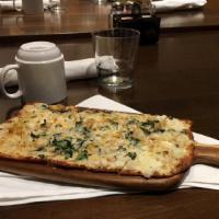 Chesapeake Flatbread · Cream cheese, spinach, crabmeat, old bay, mozzarella cheese.