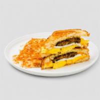 U.B.S (The Ultimate Breakfast Sandwich) · Applewood bacon, sausage, egg over medium*, scrambled egg, cheddar cheese, griddled toast, s...
