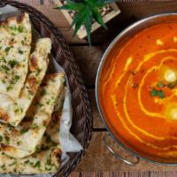 Butter Chicken · Tandoori chicken pieces cooked with onions, tomatoes, butter and cream served with a naan br...