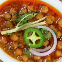 Channa Masala · Chick peas cooked with house special sauce and served with a naan bread, salad and mint sauc...
