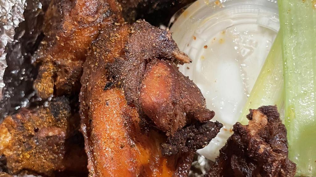 Mumbo Wings · 8 Jumbo Chicken Wings, brined and marinated, smoked and fried. Topped with scratch made Mumbo Sauce. Served with celery and ranch dressing.