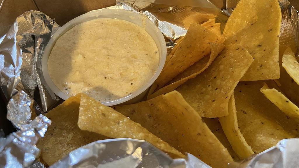 Side Of Queso Dip · 5oz of Queso Dip and Freshly Fried Tortilla Chips.